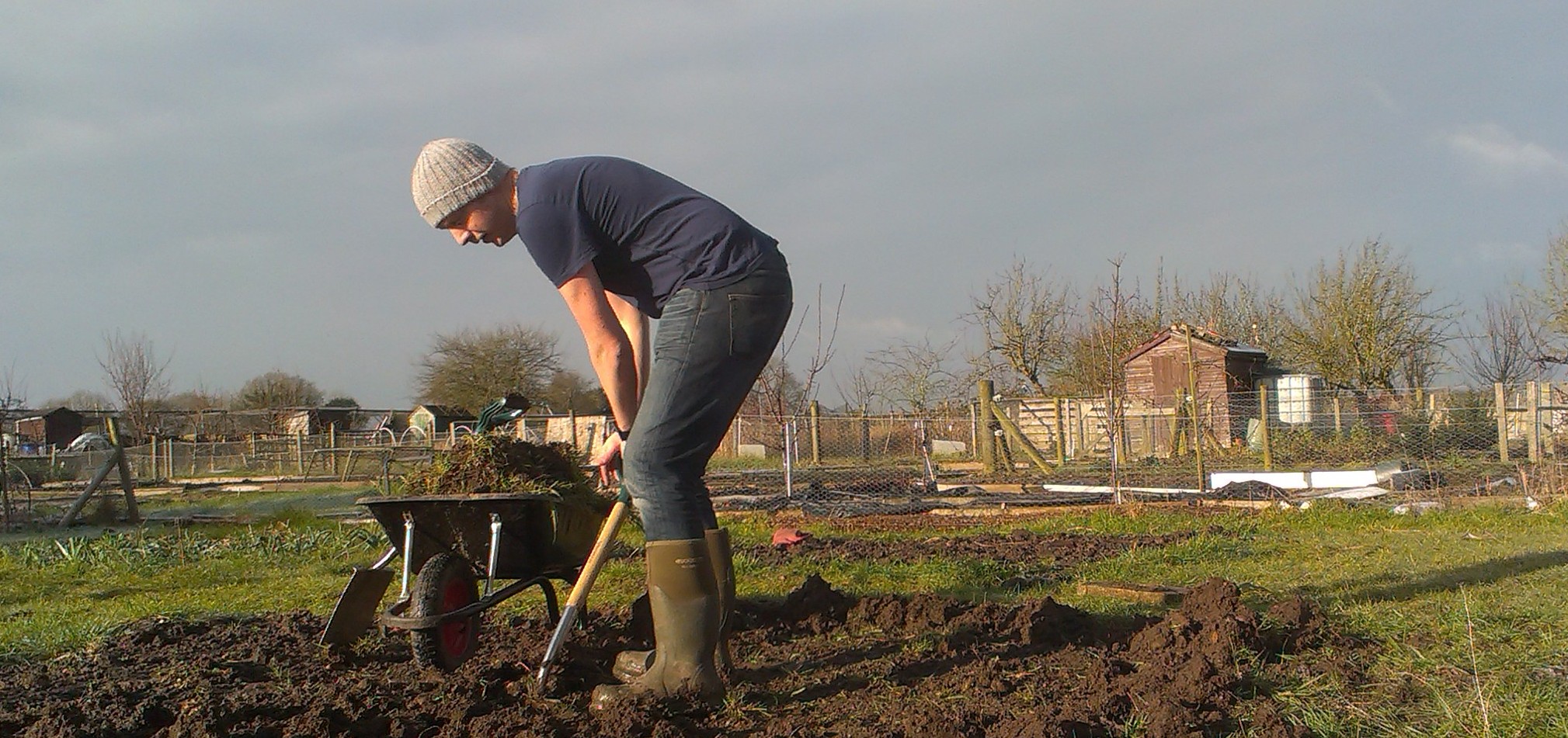 A man digging over his allotment